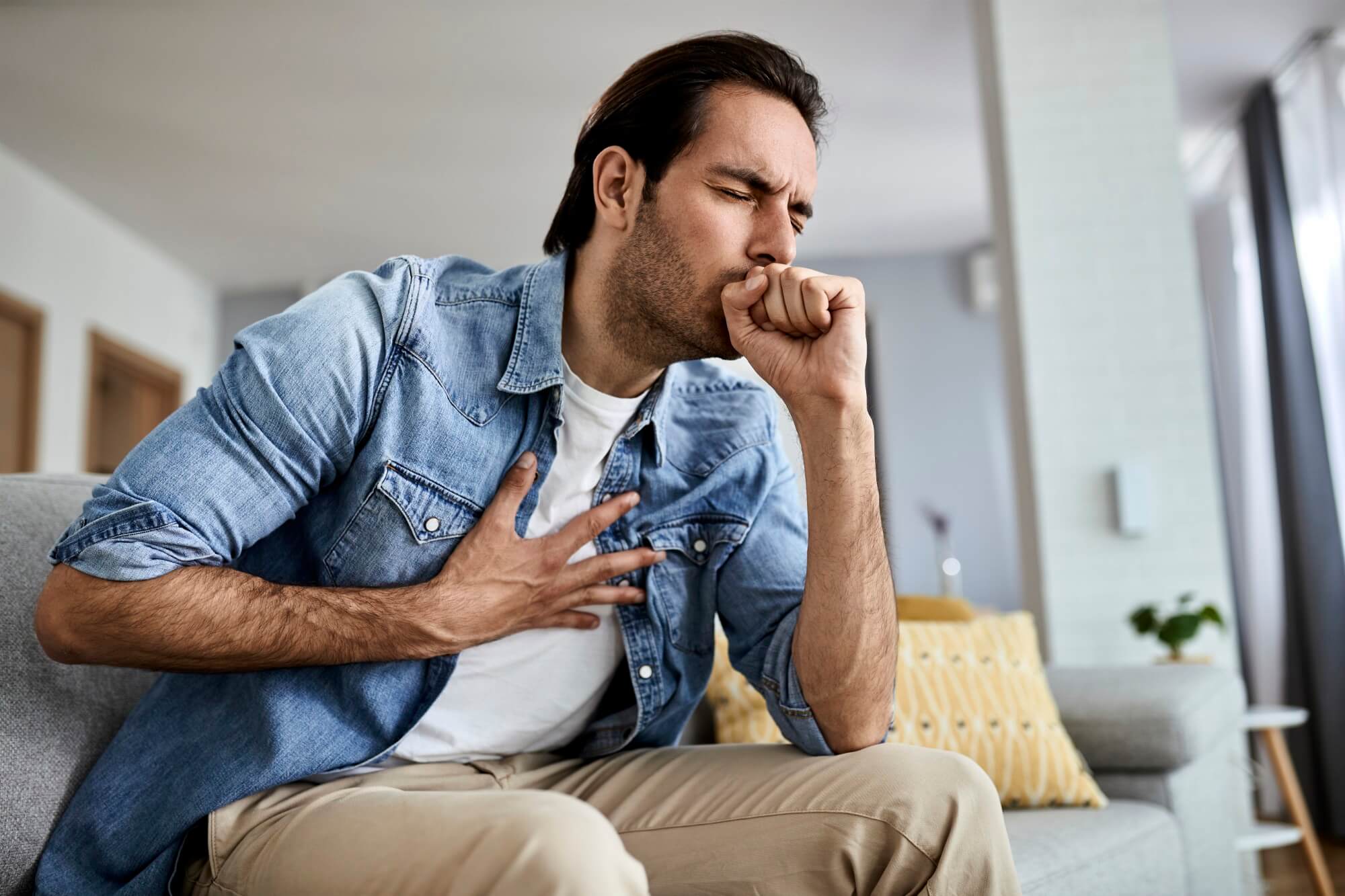 young man feeling ill and coughing at home 2024 12 13 16 36 10 utc.jpg